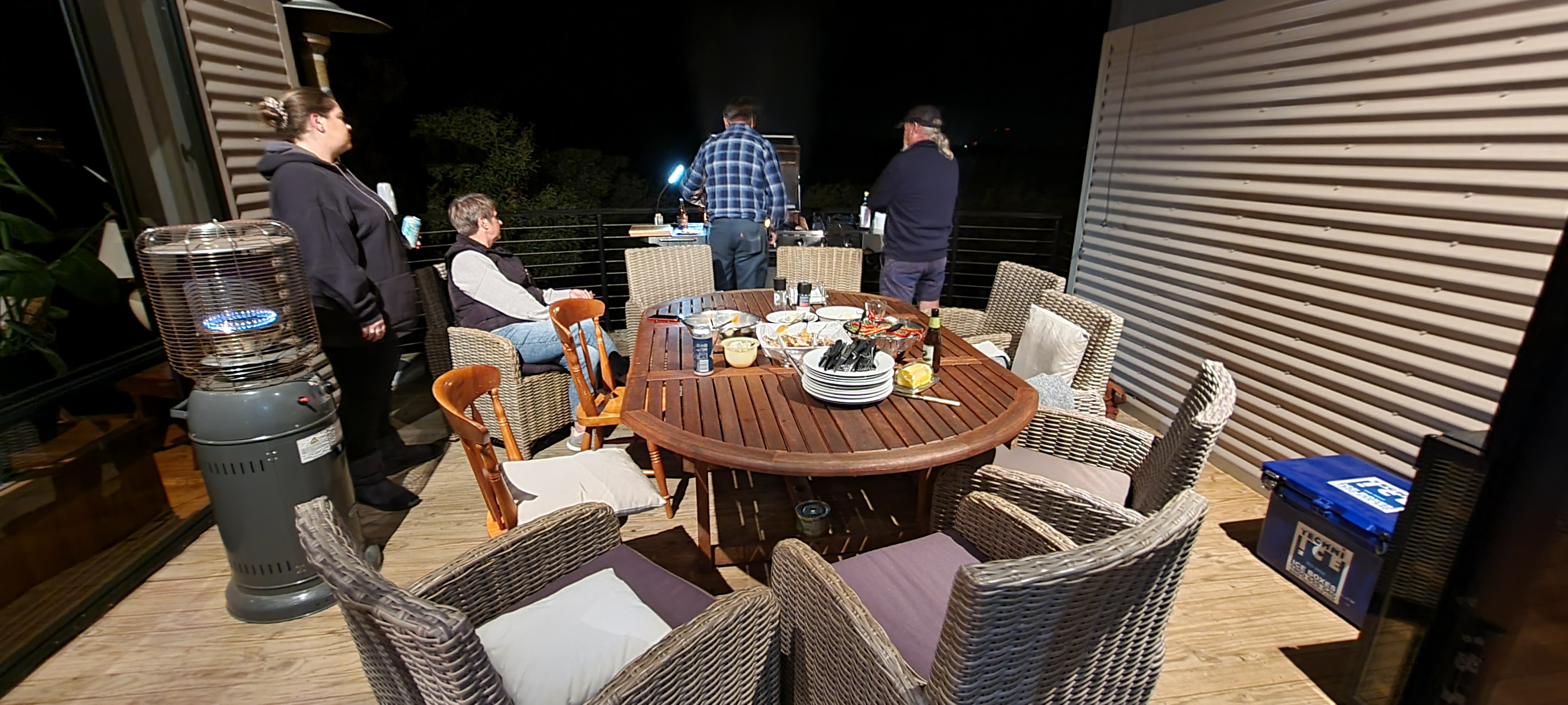 Karen and friends at a night-time barbecue